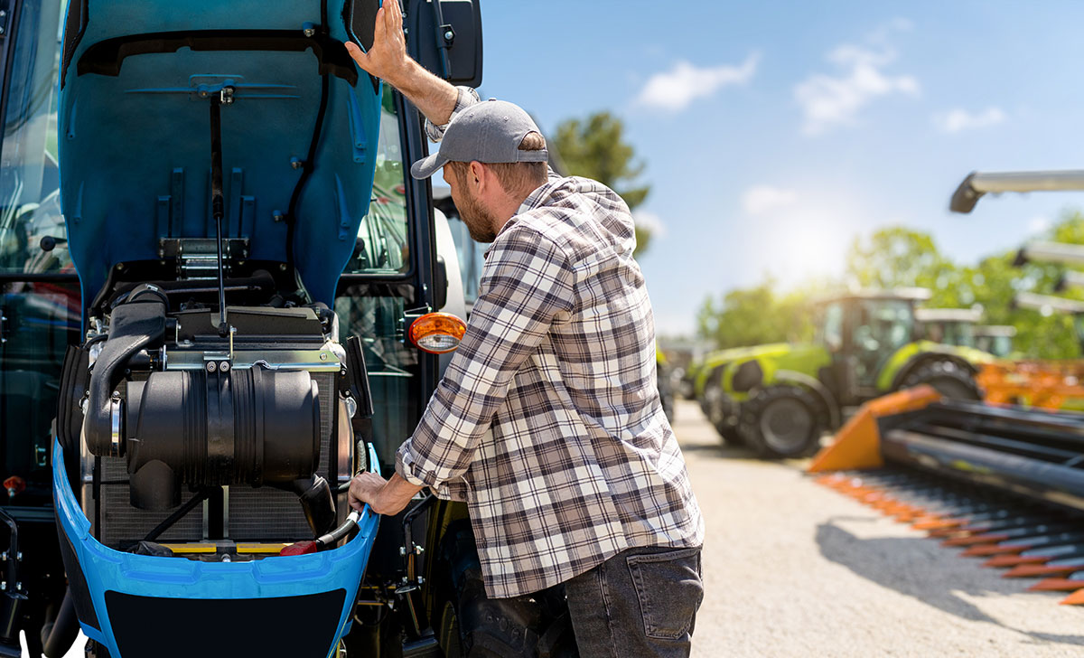 Man looking at tractor, trying to choose the right equipment